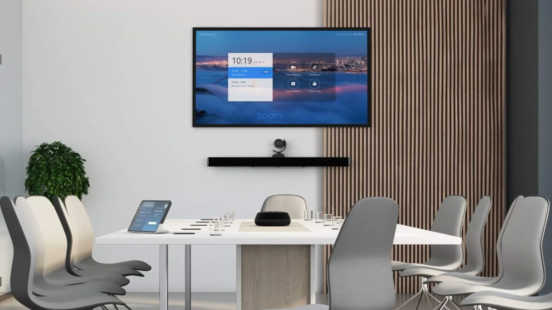 Boardroom with a wall display, soundbar, camera and conference table