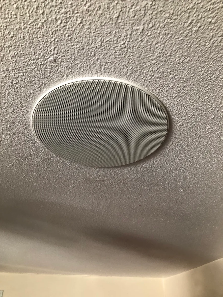Flush in-ceiling speaker installed in a ceiling